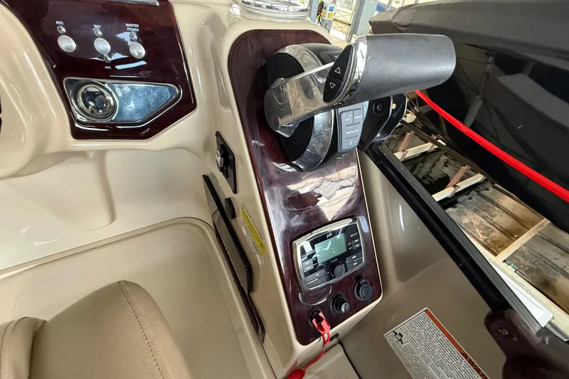 Slide: The Image of 2016 Starcraft MX 25 DL boat dashboard with controls and steering wheel. - 12