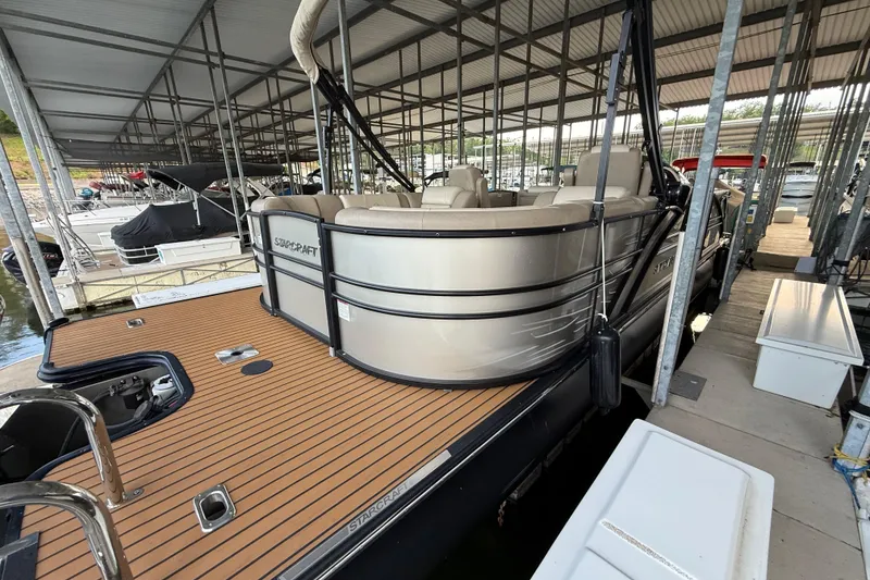 Slide: The Image of 2016 Starcraft MX 25 DL pontoon boat docked under covered marina. - 3