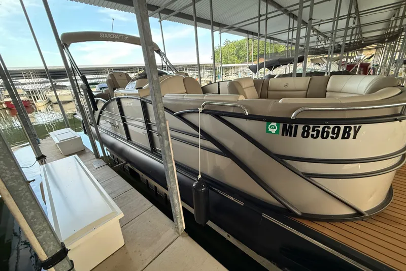 Slide: The Image of 2016 Starcraft MX 25 DL pontoon boat docked in a marina. - 4