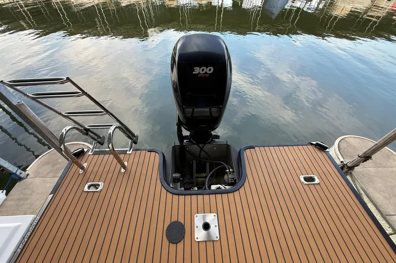 Slide: The Image of 2016 Starcraft MX 25 DL boat with 300 Pro motor on calm water. - 6