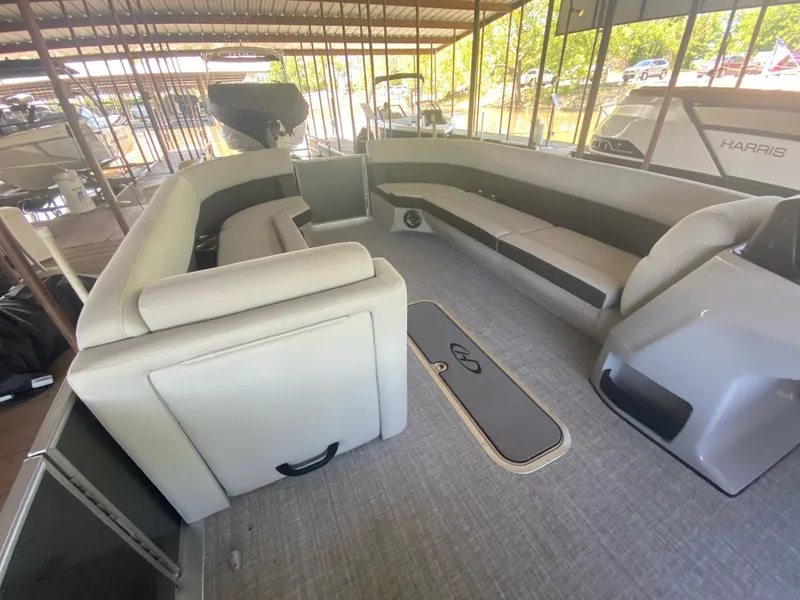 Slide: The Image of Interior of a 2024 Harris 250CX pontoon boat with gray seating. - 11