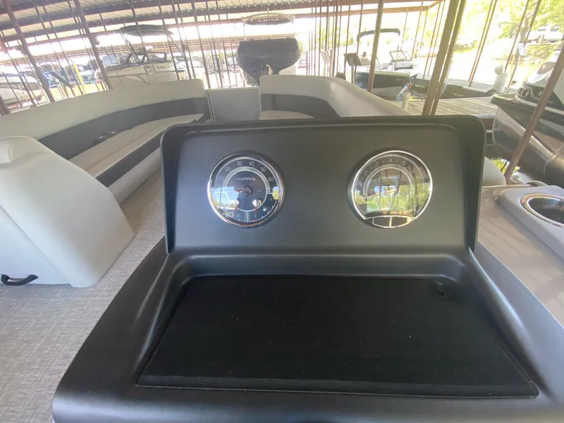 Slide: The Image of 2024 Harris 250CX boat with dashboard and gauges. - 15