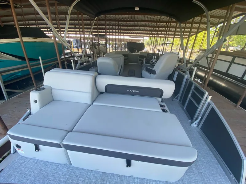 Slide: The Image of 2024 Harris 250CX pontoon boat with luxurious interior seating. - 16
