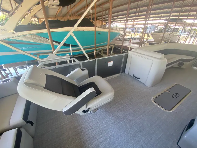 Slide: The Image of Interior of a 2024 Harris 250CX pontoon boat with luxurious seating. - 17