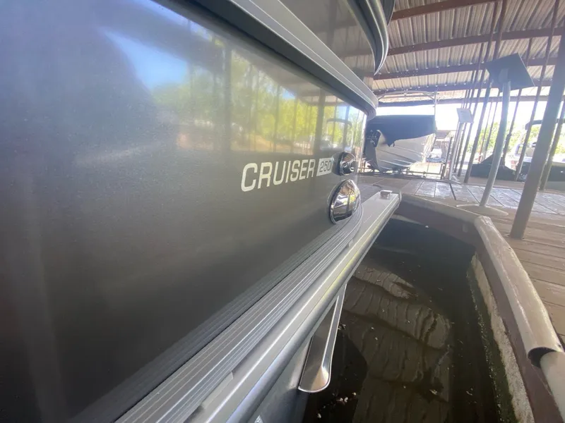 Slide: The Image of 2024 Harris 250CX Cruiser docked, side view. - 6