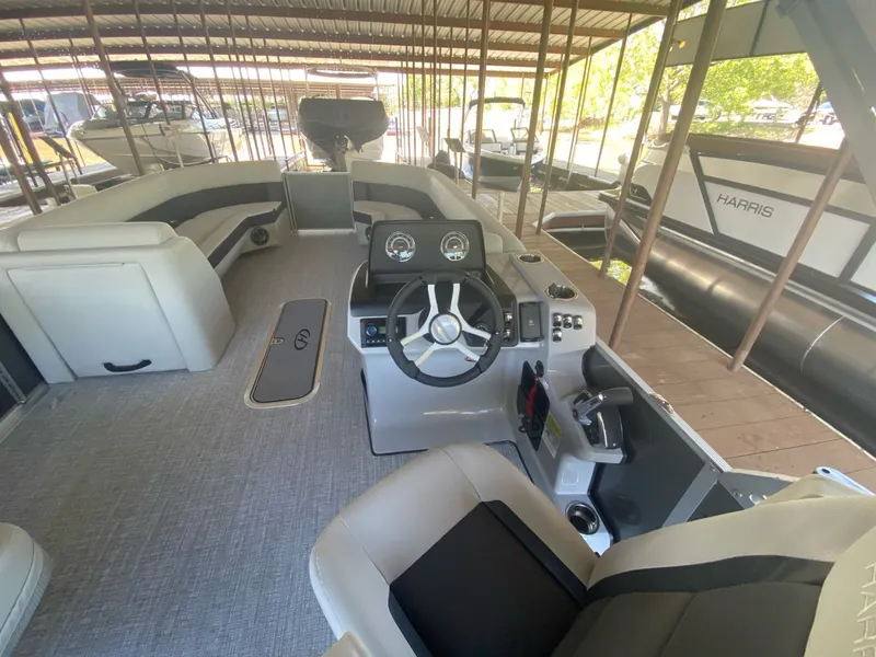 Slide: The Image of Interior of 2024 Harris 250CX pontoon boat with modern helm station. - 7