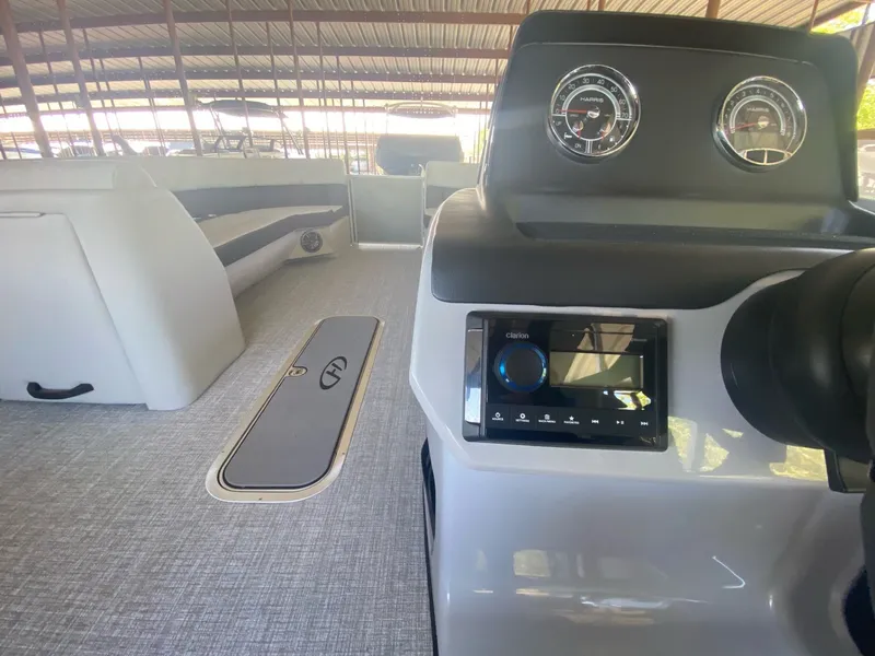 Slide: The Image of Interior of 2024 Harris 250CX with dashboard and seating area. - 9