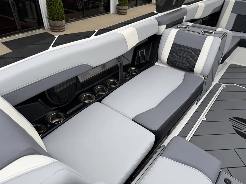 Slide: The Image of Interior of 2023 Malibu 26LSV with gray seating and cup holders. - 12