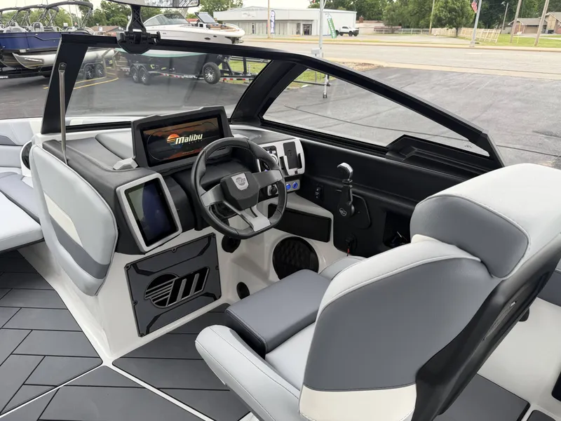 Slide: The Image of Interior of 2023 Malibu 26LSV boat with modern helm console. - 15