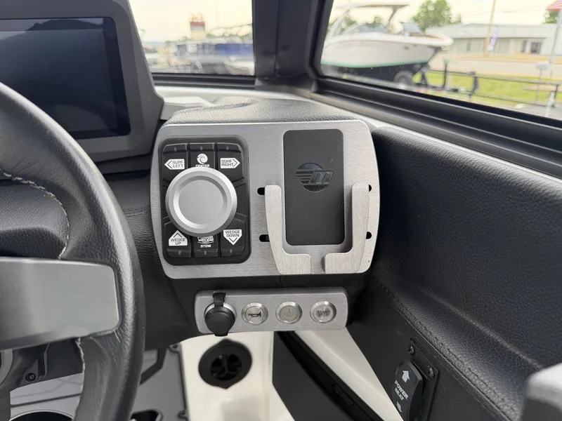 Slide: The Image of Interior view of 2023 Malibu 26LSV boat control panel. - 18