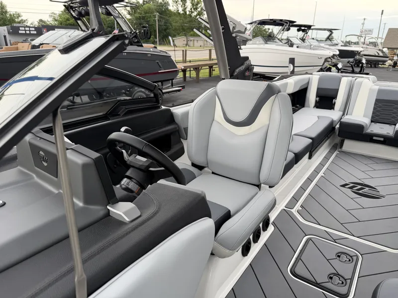Slide: The Image of Interior of a 2023 Malibu 26LSV boat with gray seating. - 22