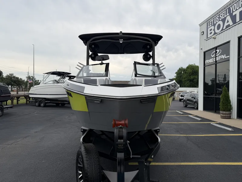Slide: The Image of 2023 Malibu 26LSV boat in front of a boat dealership. - 3