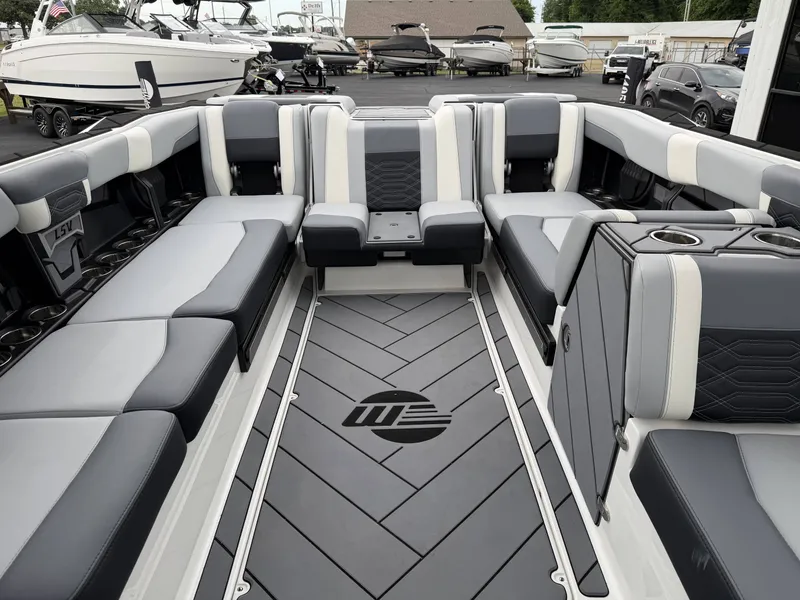 Slide: The Image of Interior of a 2023 Malibu 26LSV boat with gray seating. - 33
