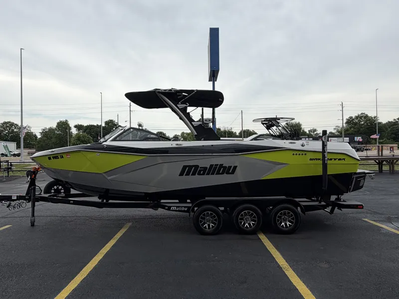 Slide: The Image of 2023 Malibu 26LSV boat parked on trailer outdoors. - 5
