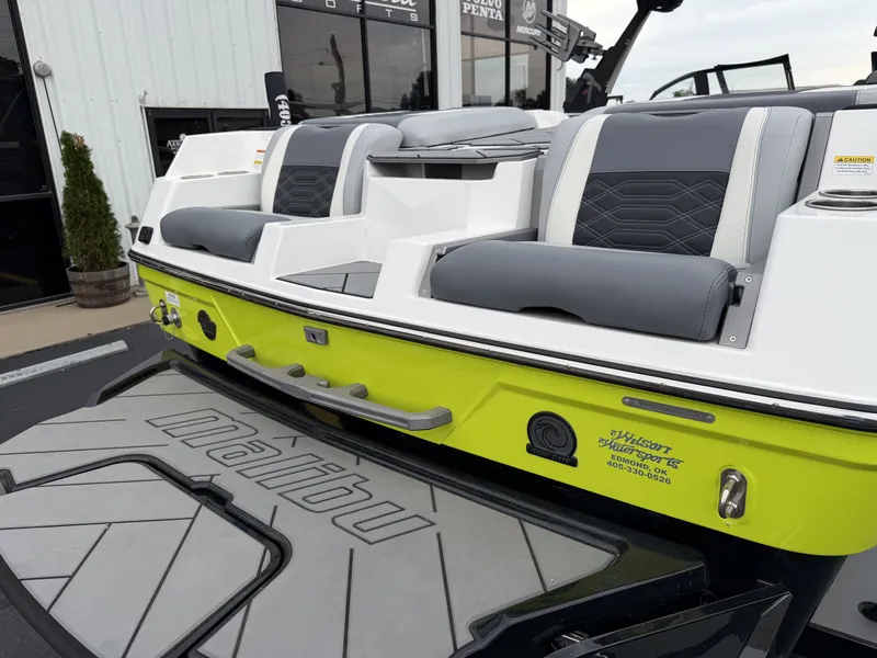 Slide: The Image of 2023 Malibu 26LSV boat with gray seats and yellow accent. - 9