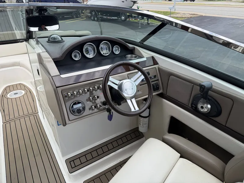 Slide: The Image of Interior of a 2013 Sea Ray 250SLX boat with steering console. - 14