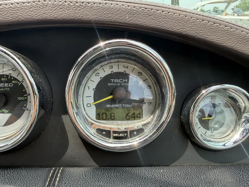 Slide: The Image of Dashboard of a 2013 Sea Ray 250SLX with tachometer and trim gauge. - 15