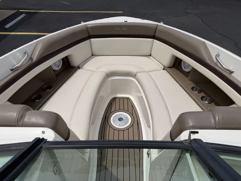 Slide: The Image of Interior of a 2013 Sea Ray 250SLX boat with beige seating. - 18