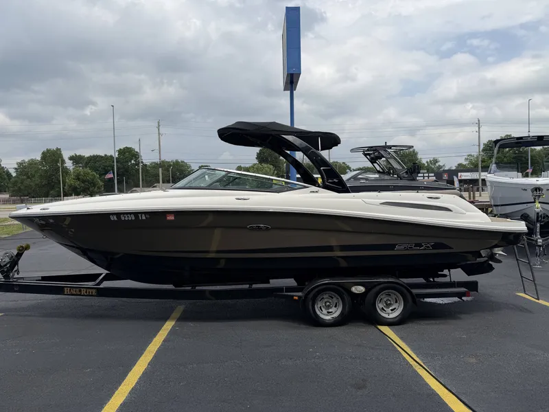 Slide: The Image of 2013 Sea Ray 250SLX boat on trailer outdoors. - 3