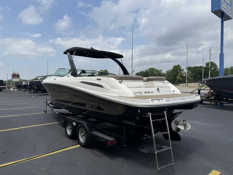 Slide: The Image of 2013 Sea Ray 250SLX boat on trailer outdoors. - 4