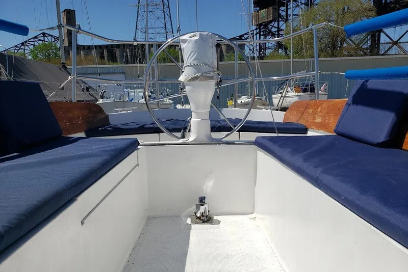 Slide: The Image of Cockpit of a 1974 Ericson 32-2 sailboat with blue cushions and steering wheel. - 11