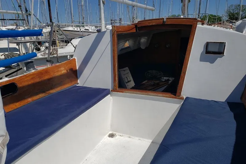 Slide: The Image of Cockpit of a 1974 Ericson 32-2 sailboat with blue cushions and wooden trim. - 13