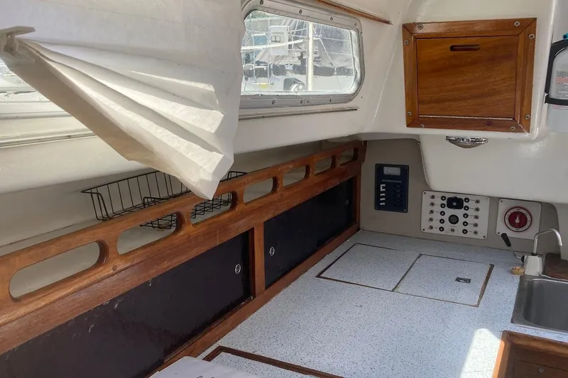 Slide: The Image of Interior of a 1974 Ericson 32-2 sailboat with wood accents and control panel. - 18