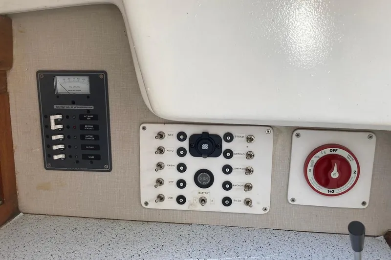 Slide: The Image of Control panel of a 1974 Ericson 32-2 sailboat with switches and battery selector. - 19