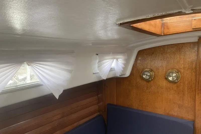 Slide: The Image of Interior of a 1974 Ericson 32-2 sailboat with wood paneling and portholes. - 22