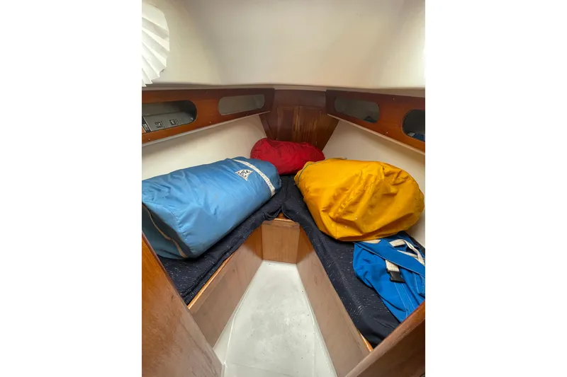Slide: The Image of Cozy cabin interior of a 1974 Ericson 32-2 sailboat with colorful sleeping bags. - 25