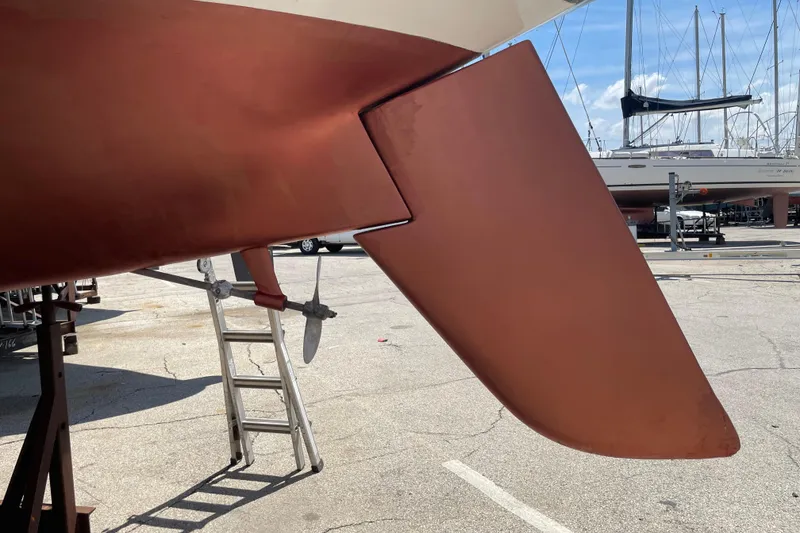 Slide: The Image of Ericson 32-2 sailboat rudder and propeller, 1974 model, in a marina setting. - 9