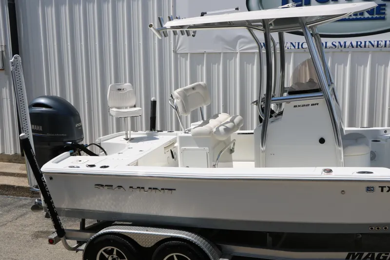 Slide: The Image of 2016 Sea Hunt BX 22 BR boat with Yamaha engine, parked on a trailer. - 11