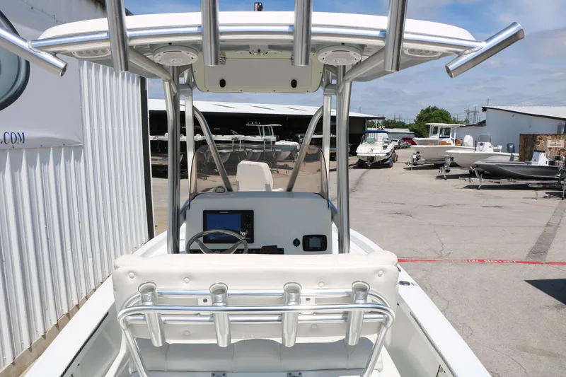 Slide: The Image of 2016 Sea Hunt BX 22 BR boat with T-top and console, parked in a marina. - 20