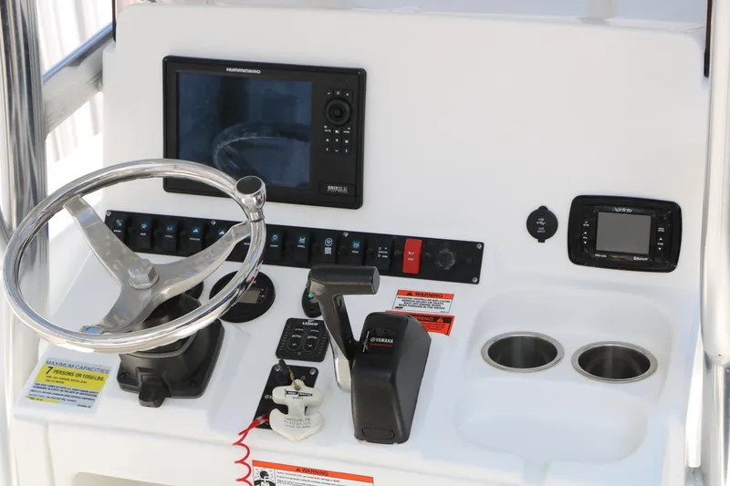 Slide: The Image of 2016 Sea Hunt BX 22 BR boat console with steering wheel and electronic controls. - 23