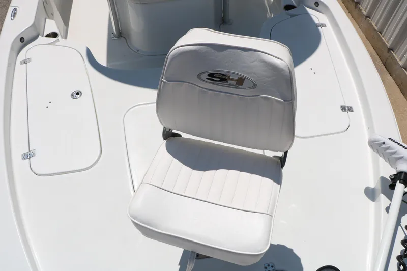 Slide: The Image of 2016 Sea Hunt BX 22 BR boat interior with white seating and storage compartments. - 26