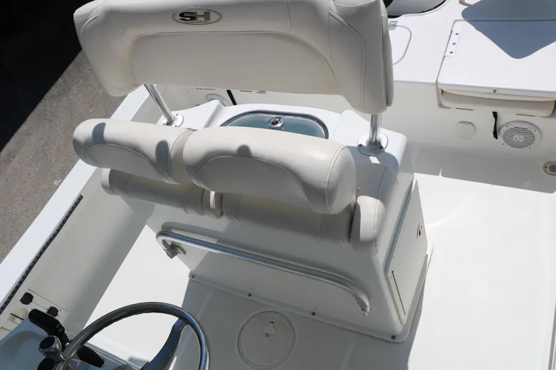 Slide: The Image of 2016 Sea Hunt BX 22 BR boat interior with white seating and steering wheel. - 31