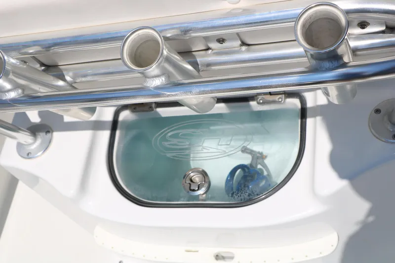 Slide: The Image of 2016 Sea Hunt BX 22 BR boat livewell with rod holders and clear lid. - 45