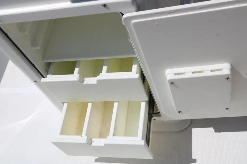 Slide: The Image of Storage compartments on a 2016 Sea Hunt BX 22 BR boat, featuring organized drawers. - 49