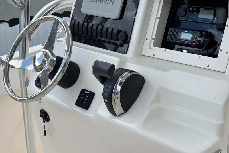 Slide: The Image of Center console of 2004 Key West 2220 boat with steering wheel and navigation equipment. - 12