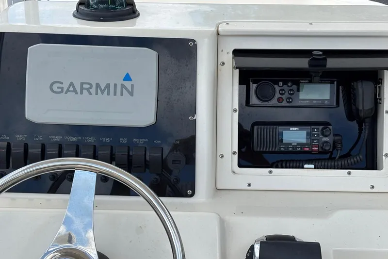 Slide: The Image of Center console of 2004 Key West 2220 with Garmin navigation and communication equipment. - 13