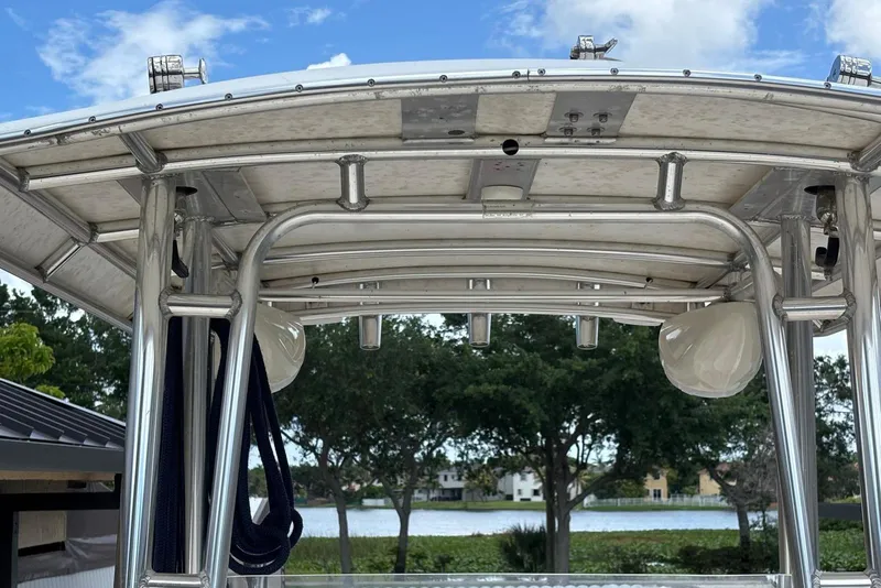 Slide: The Image of T-top structure of a 2004 Key West 2220 Center Console boat against a lake backdrop. - 17