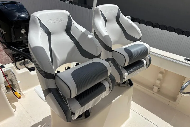 Slide: The Image of Two cushioned boat seats on a 2004 Key West 2220 Center Console. - 3