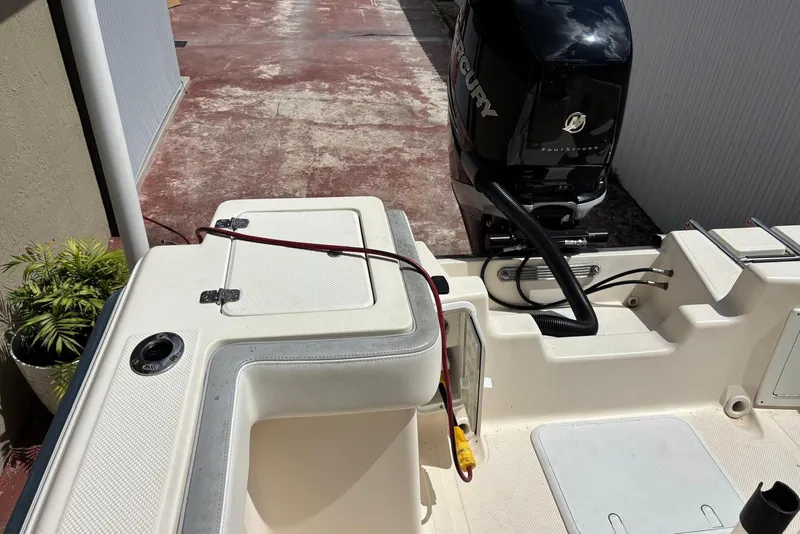 Slide: The Image of 2004 Key West 2220 Center Console boat with Mercury outboard engine, docked outdoors. - 5
