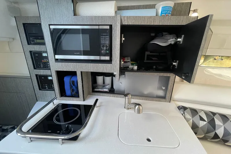 Slide: The Image of COMPACT GALLEY WITH MICROWAVE, SINGLE BURNER ELECTRIC COOKTOP, HOT/COLD SINK, WITH STORAGE CABINETRY - 19