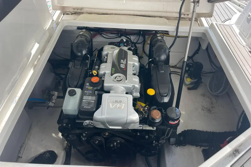 Slide: The Image of ENGINE COMPARTMENT WITH UPGRADED 8.2 BIG BLOCK ENGINE THAT IS FRESH WATER COOLED, 380HP, AND COUPLED WITH A BRAVO III DRIVE. EXACTLY THE RIGHT ENGINE PACKAGE AND PRICEY UPGRADE!! - 64