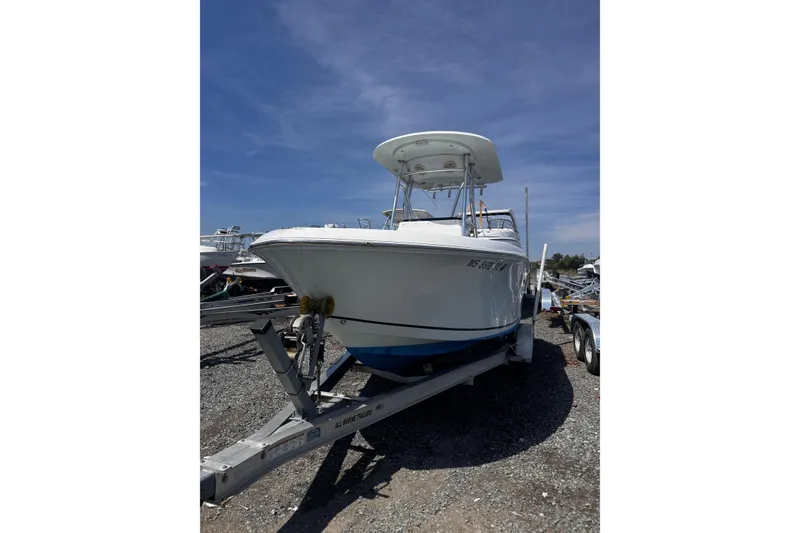 The Image of 2017 Release 210RX boat on trailer under clear blue sky. - 1