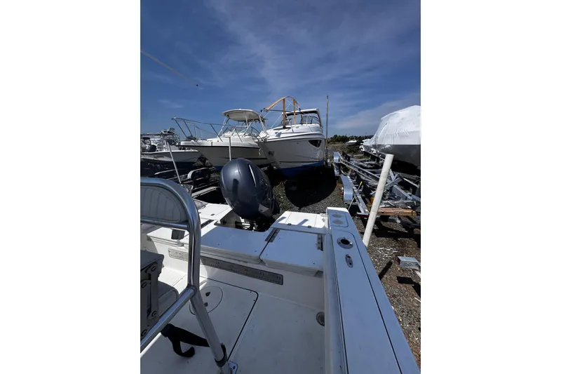 Slide: The Image of 2017 Release 210RX boat in storage yard, surrounded by other vessels under clear blue sky. - 11