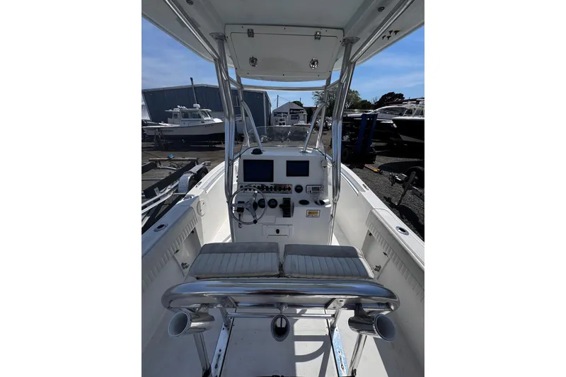 Slide: The Image of 2017 Release 210RX boat interior with dual screens and steering wheel in a marina setting. - 12