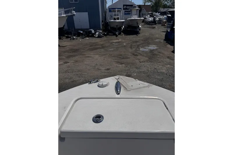 Slide: The Image of Bow view of a 2017 Release 210RX boat in a marina setting. - 19