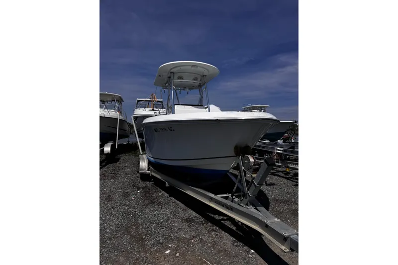 Slide: The Image of 2017 Release 210RX boat on trailer under clear blue sky. - 2